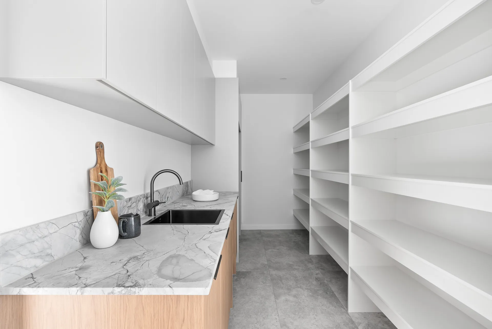 Butler's pantry with marble benchtop and open shelving in the Scott home