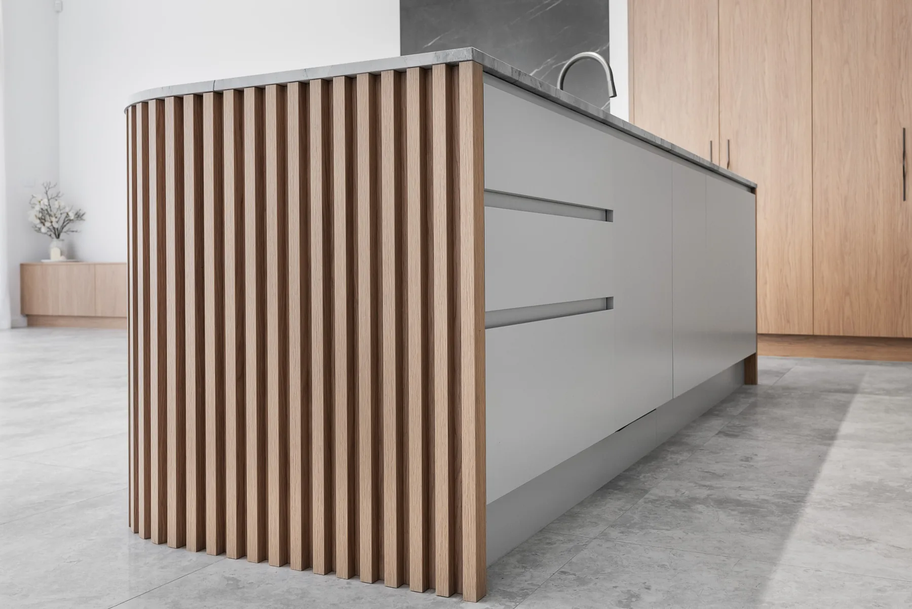 Fluted timber detail on the curved end of the kitchen island in the Scott home