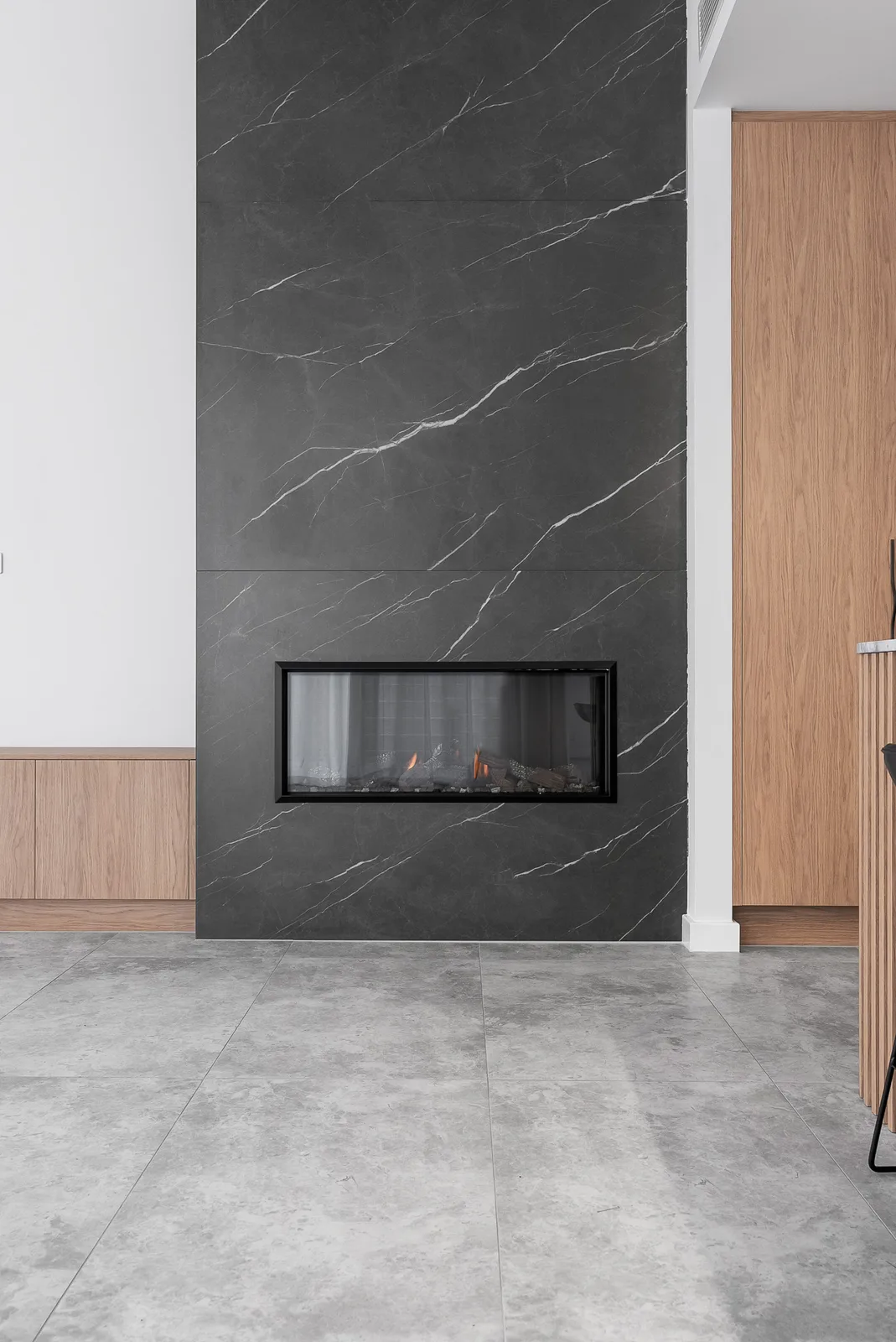 Full height stone fireplace wall with linear gas fire in the Scott home