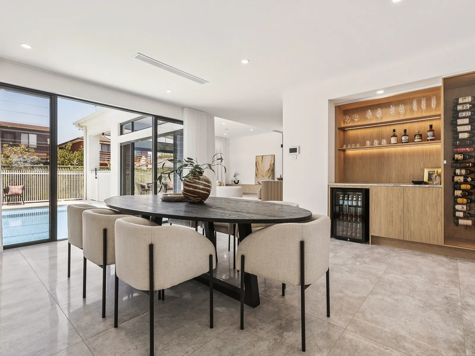 Dining area with built-in bar and pool outlook in the Scott home
